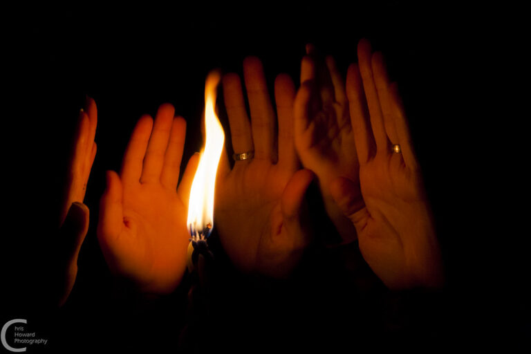 hands being held up to havdalah flame