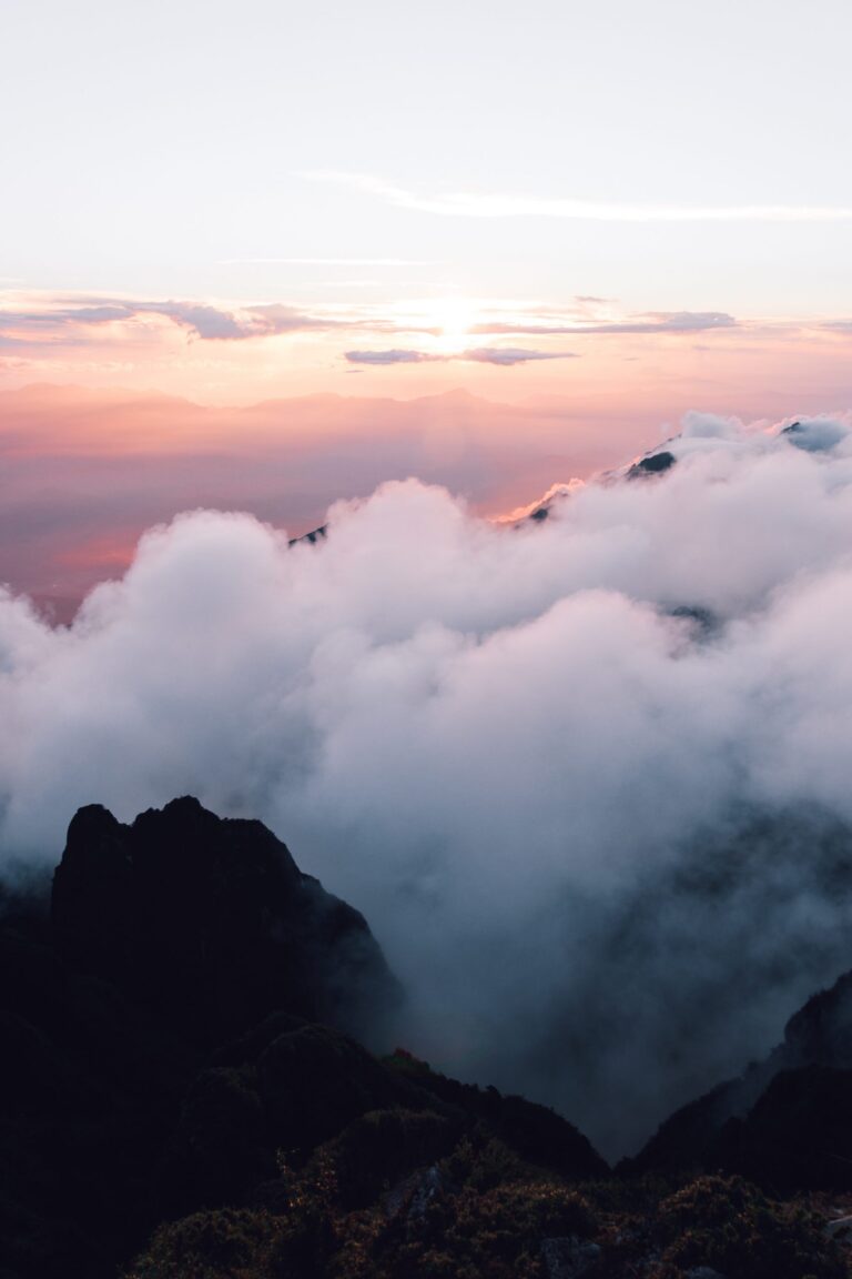 clouds and pink sky above mountains