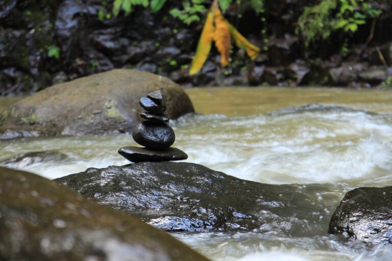 balancing pile of stones in rushing water