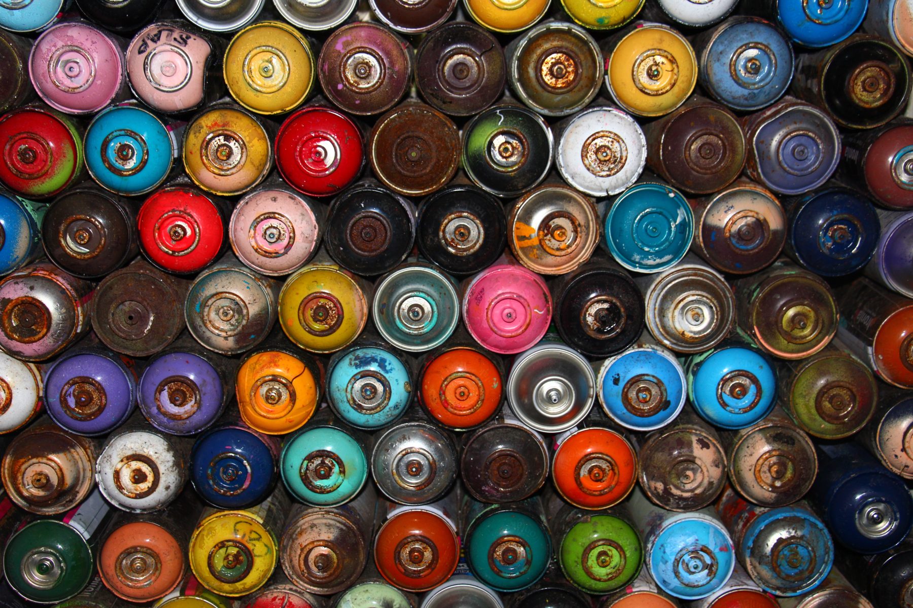 many colorful spraypaint cans from above