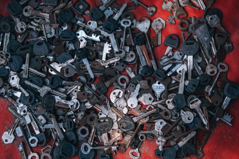 piles of metal keys on red surface