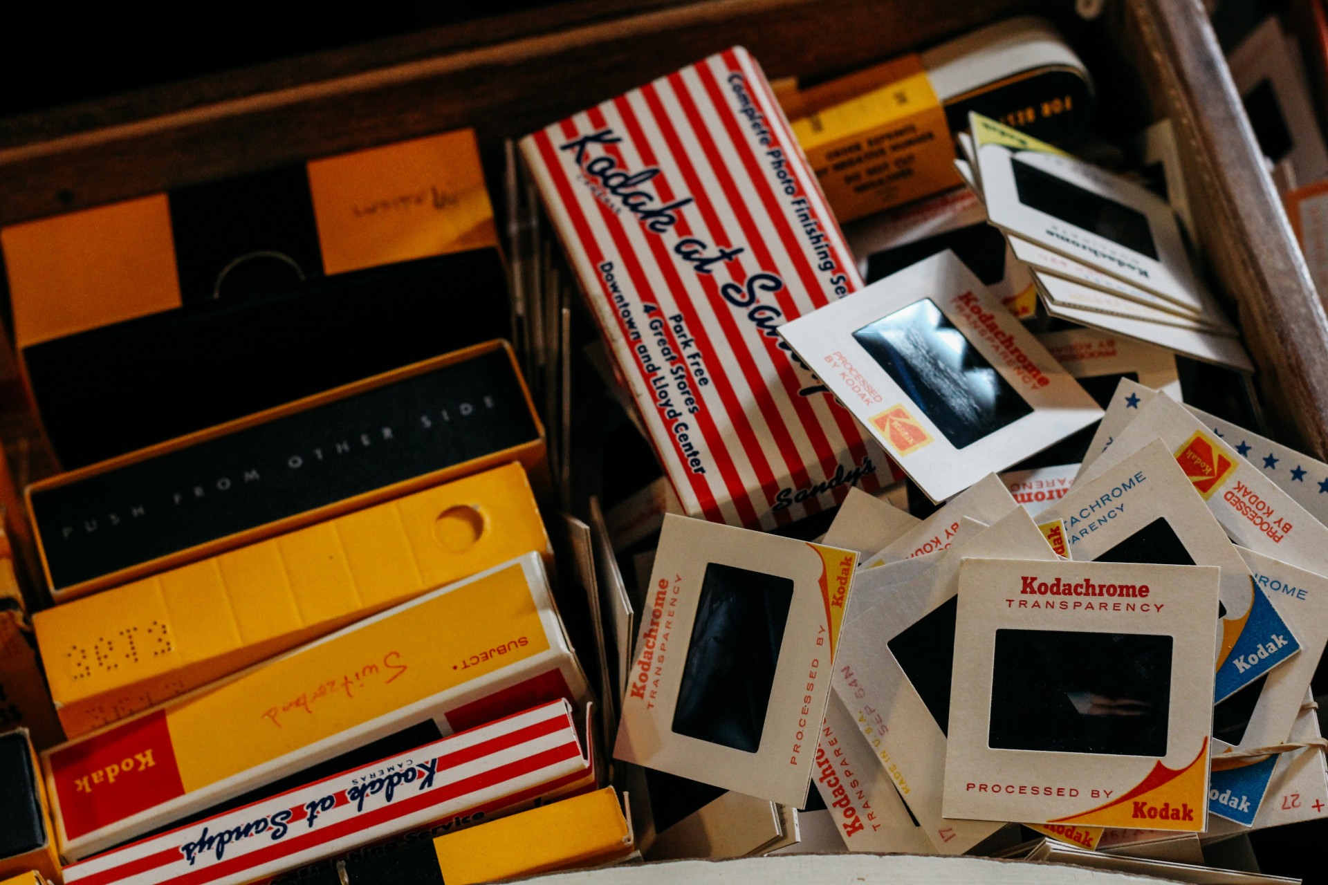 A collection of vintage Kodachrome slides and boxes with colorful packaging.