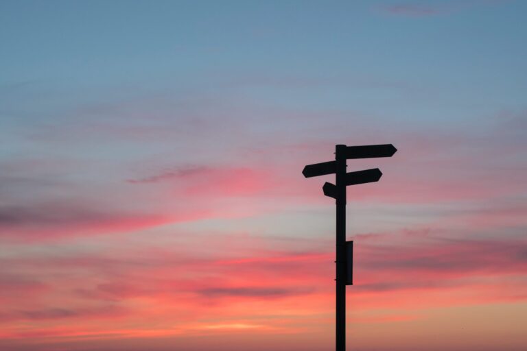 signpost against sunset