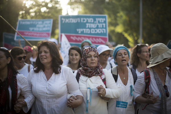 women in white marching in Jerusalem