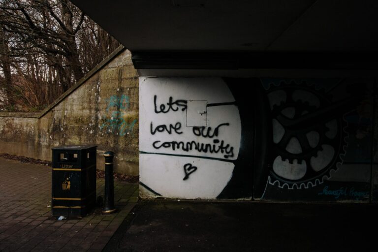underpass with graffiti reading "let's love our community"