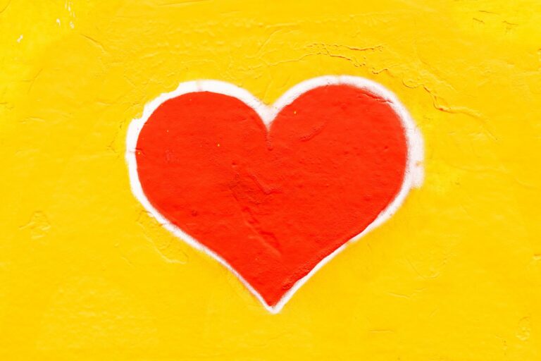 drawing of red heart shape on yellow background