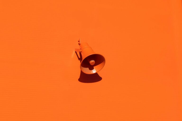 bright orange megaphone on bright orange background