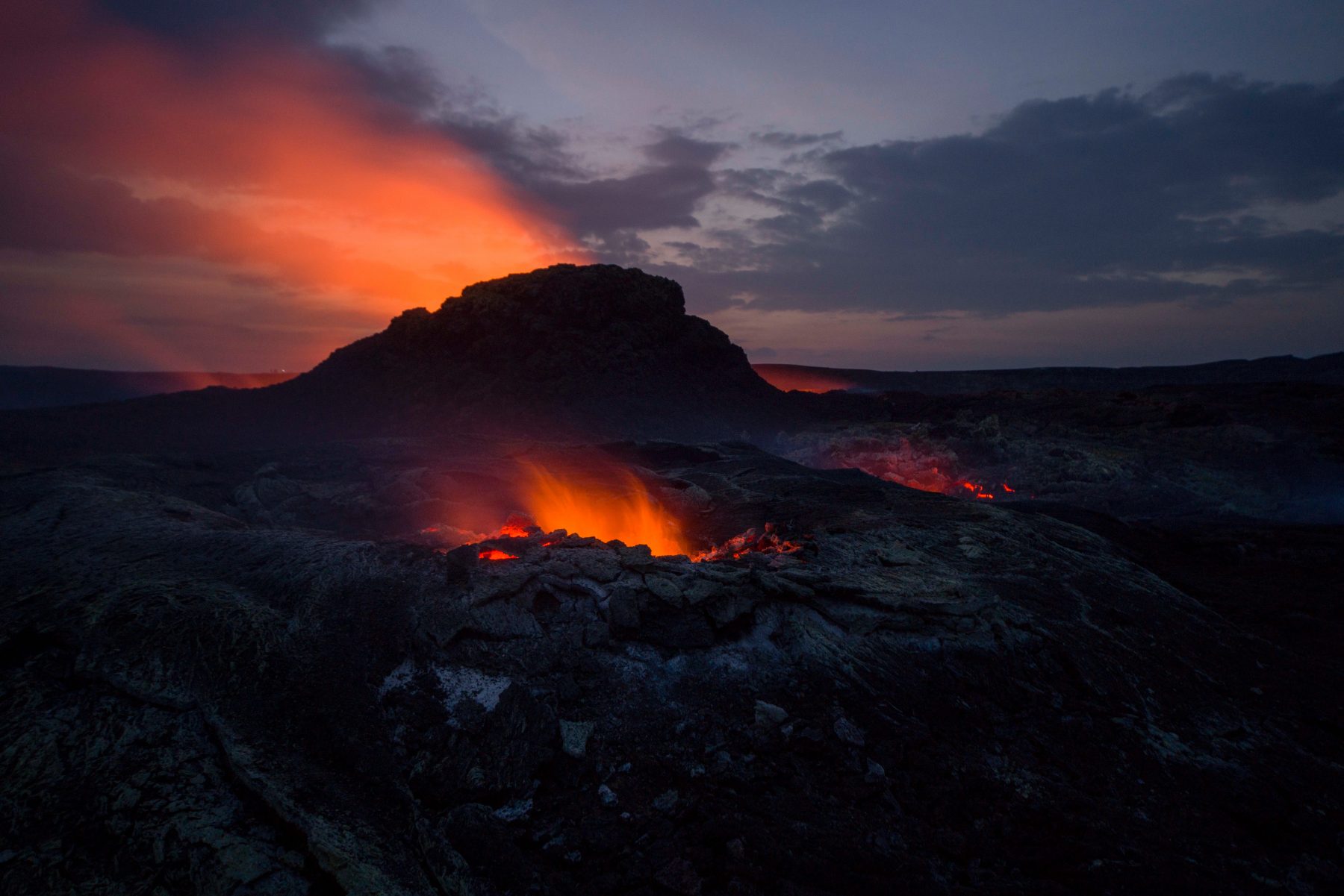 fire in front of mountain, with setting sun