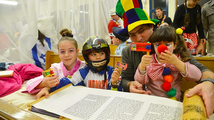 costumed kids and adult with open megillah