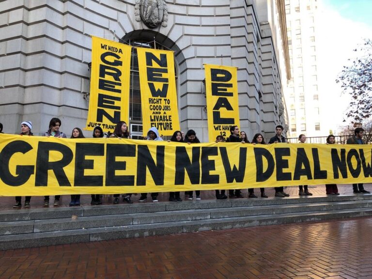 demonstrators with large Green New Deal banners
