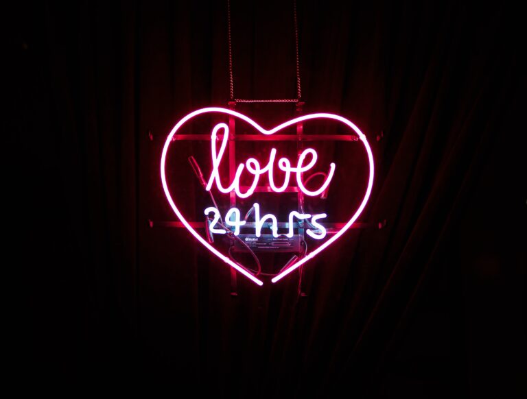 neon pink heart reading "love - 4 hours"