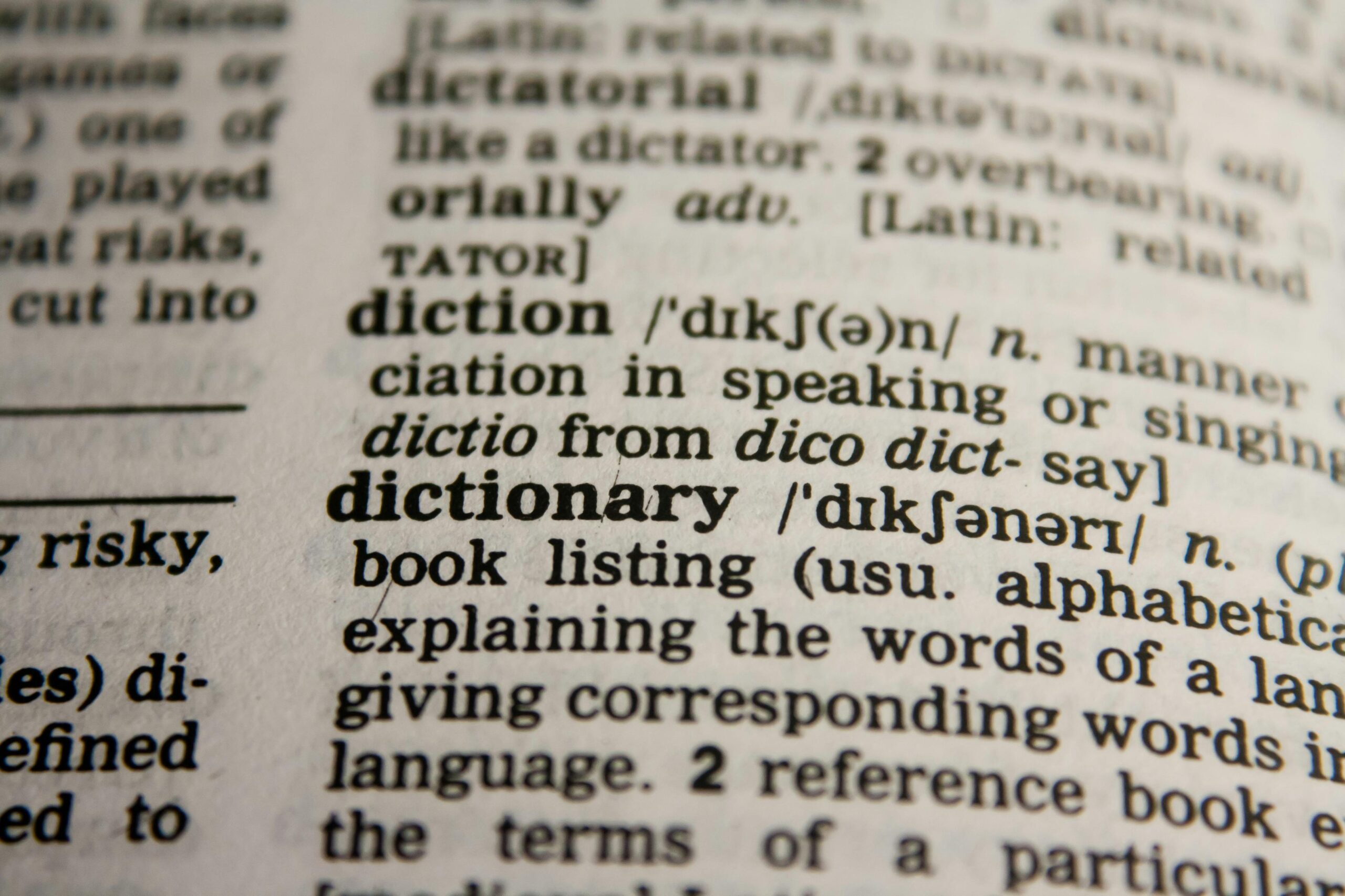Close-up of a dictionary page showing the definition of the word dictionary.