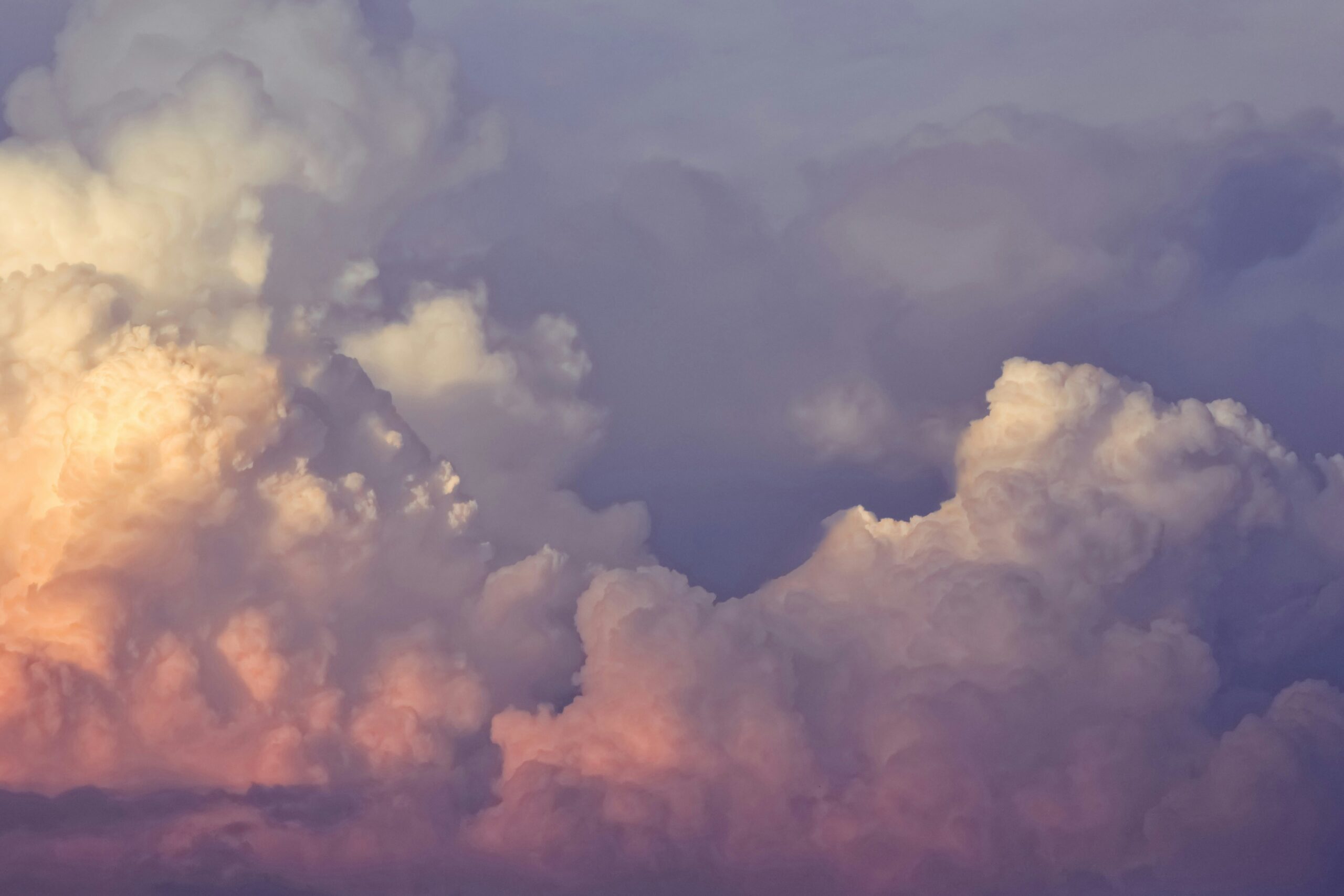 Colorful clouds with soft hues of pink, purple, and white in a serene sky.