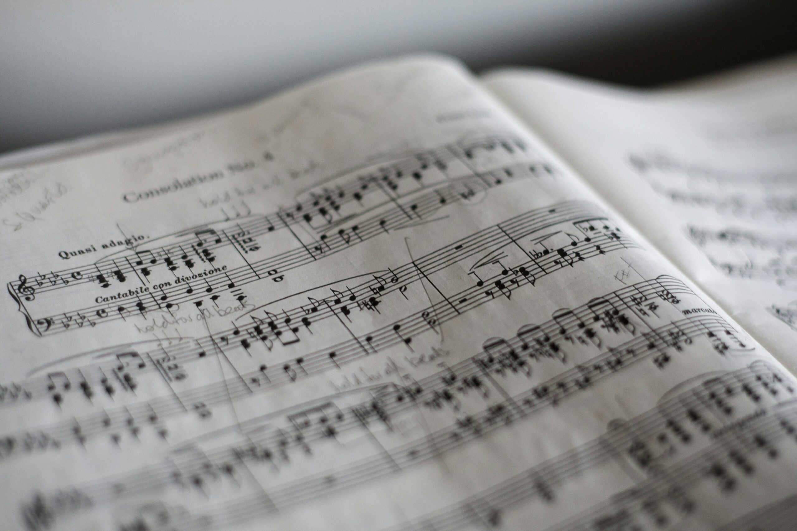 Close-up of a sheet of classical music with handwritten notes and markings on the pages.