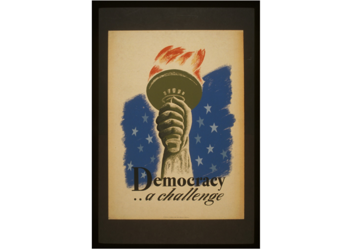 A hand holds the Statue of Liberty’s torch with stars behind and text: “Democracy… a challenge.”.