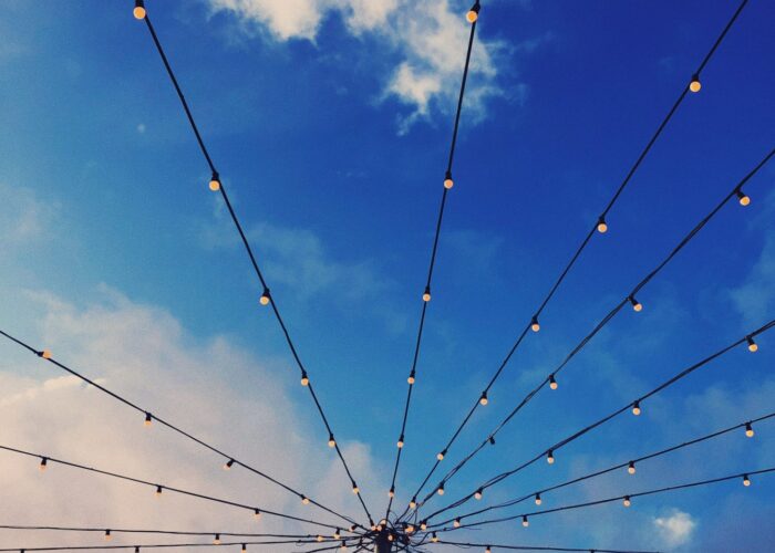 stringed lights extending from pole like spokes
