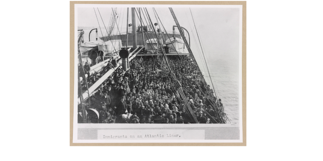 A crowded ship deck filled with immigrants crossing the Atlantic Ocean in the early 1900s.
