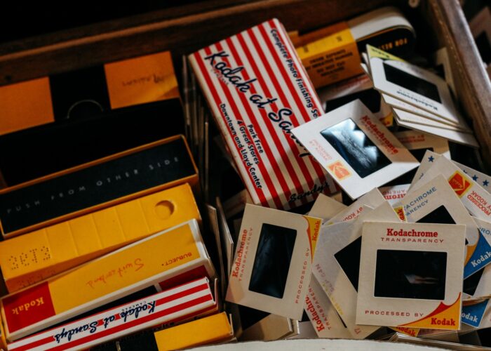 A collection of vintage Kodachrome slides and boxes with colorful packaging.