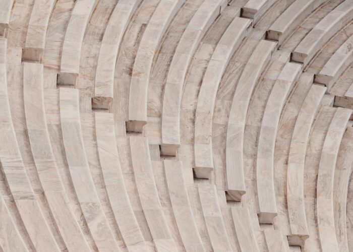Close-up of curved stone steps in an amphitheater, showcasing repeating patterns and textures.