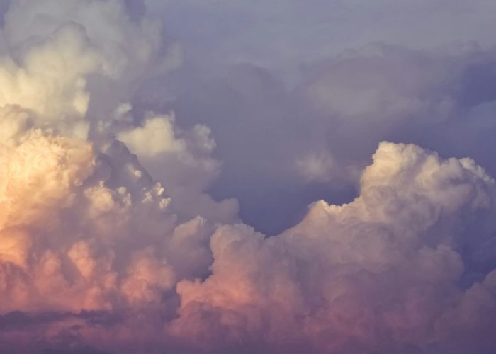 Colorful clouds with soft hues of pink, purple, and white in a serene sky.