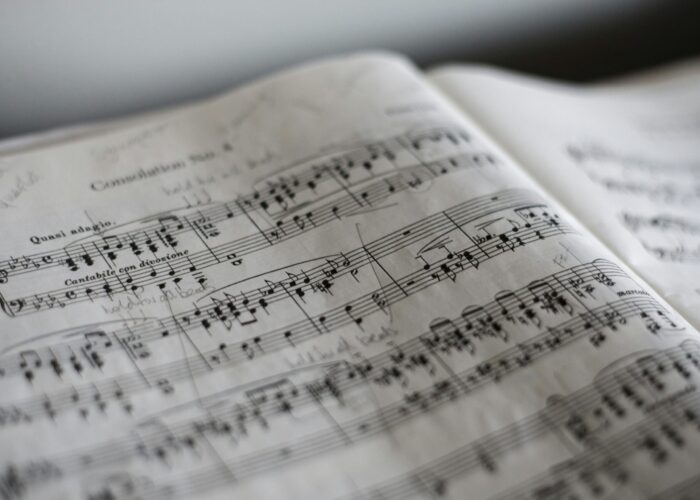 Close-up of a sheet of classical music with handwritten notes and markings on the pages.
