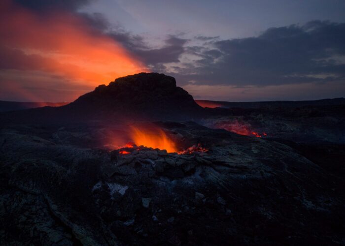 fire in front of mountain, with setting sun