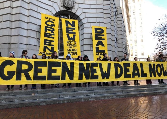 demonstrators with large Green New Deal banners